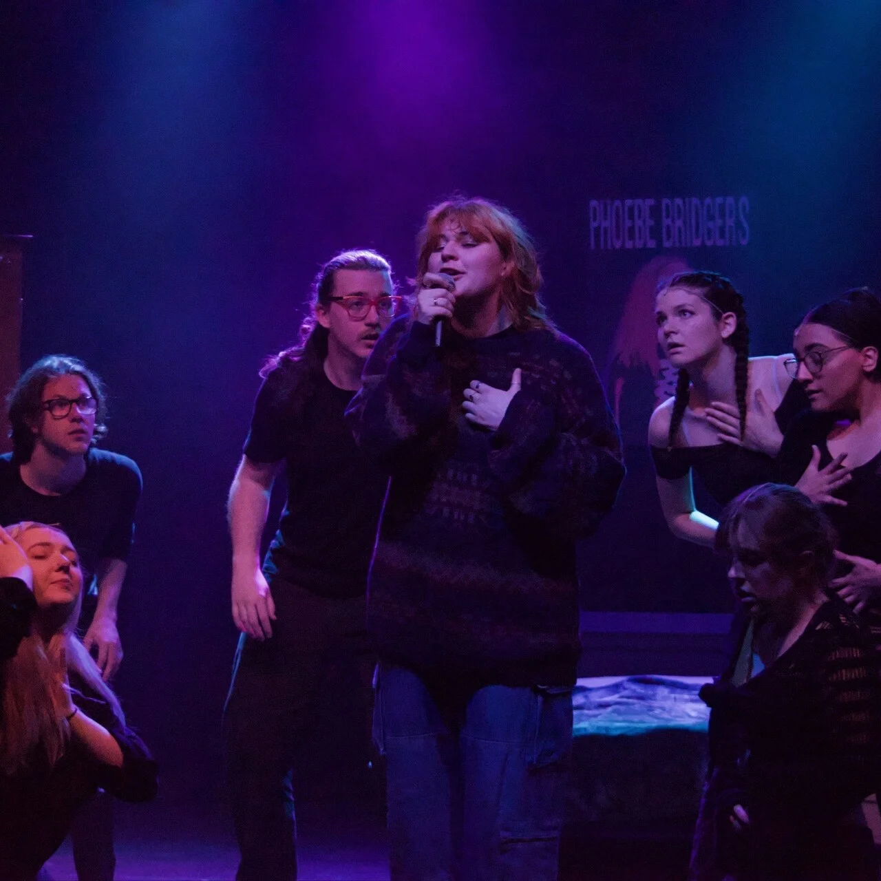 Group of singers and theatre actors performing onstage.